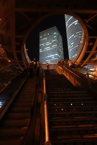 Low angle view of illuminated staircase in building at night