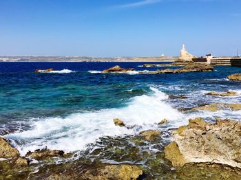 Scenic view of sea against clear blue sky