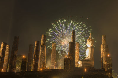 Low angle view of firework display in sky at night