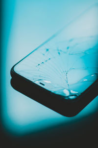 Close-up of mobile phone over black background