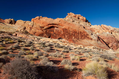 Scenic view of rocky mountains against clear blue sky