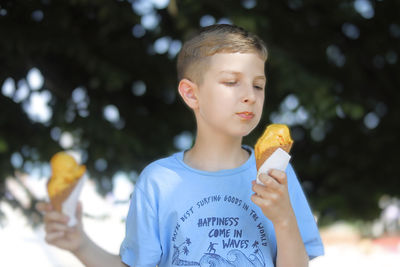 Portrait of boy eating food