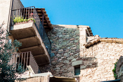 Low angle view of old building against blue sky