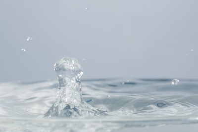 Close-up of water splashing against white background