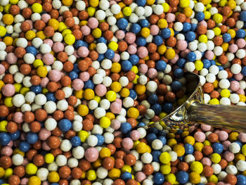 Full frame shot of colorful candies with spoon