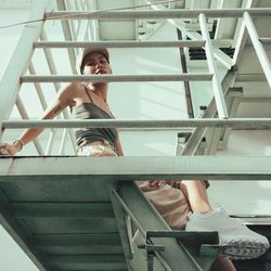 Low angle view of woman standing on staircase