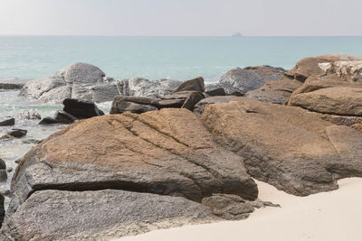 Rocks on beach against sky