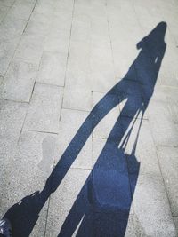 High angle view of shadow of person on road