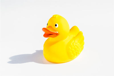 Close-up of yellow toy over white background