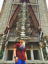 Full length of woman standing against building