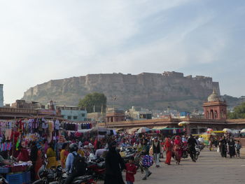 People at temple against sky