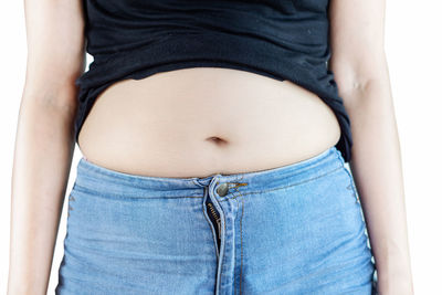 Midsection of woman standing against white background