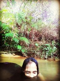 Portrait of woman against plants