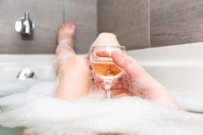 Midsection of man having food in bathroom at home