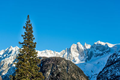 Scenic view of snowcapped mountains against clear blue sky