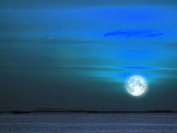 Close-up of moon over sea against sky