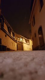 Low angle view of illuminated house against sky at night