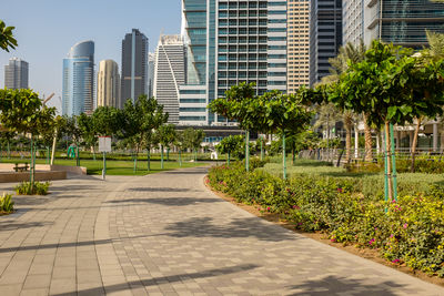 Footpath amidst buildings against sky