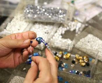 Close-up of person hands making decoration