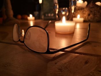 Close-up of illuminated tea light candles on table