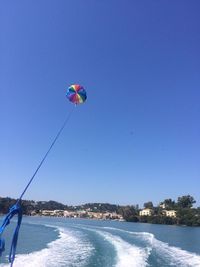 View of balloons flying against clear blue sky