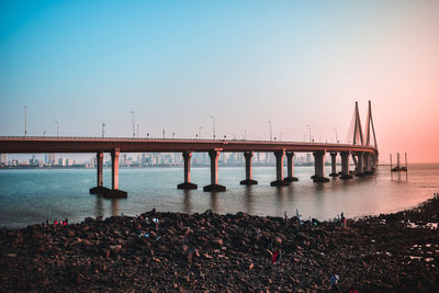 Bridge over sea against clear sky