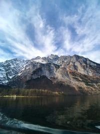 Scenic view of snowcapped mountain against cloudy sky