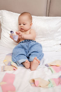 Cute baby boy sleeping on bed at home