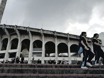 Low angle view of people against sky