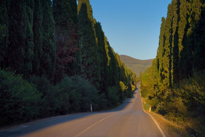 Road amidst mountains against clear sky