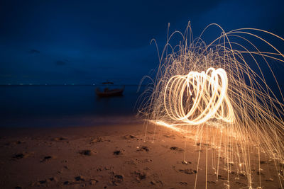 Wire wool spinning at beach during night