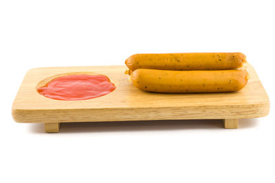 High angle view of bread on cutting board against white background