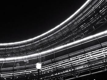 Low angle view of light trails against sky at night