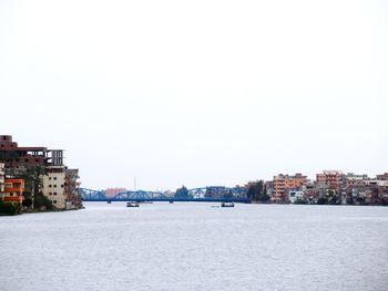 City by sea against clear sky