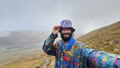 Rear view of man standing on mountain