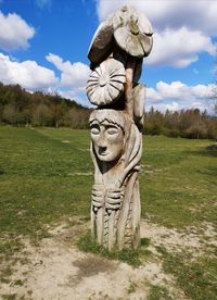 Statue against sky on field