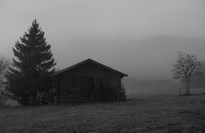 Abandoned house on field against sky