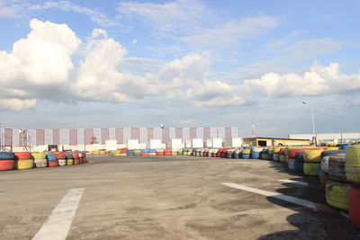 Multi colored chairs on pier against sky