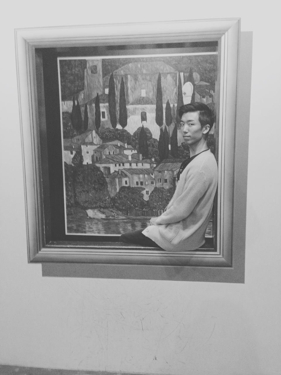 MAN LOOKING THROUGH WINDOW IN FRONT OF GLASS