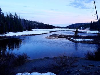 Scenic view of lake against sky during winter