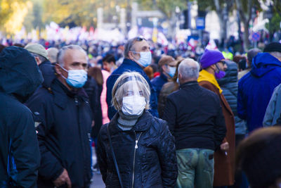 Rear view of people walking on street