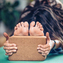 Young woman exercising with wooden block