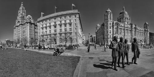  three graces liverpool and you have the beatles statues in foreground