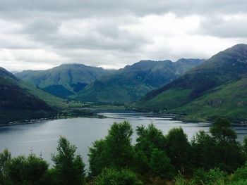 Scenic view of lake against cloudy sky