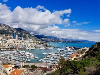 High angle view of townscape by sea against sky