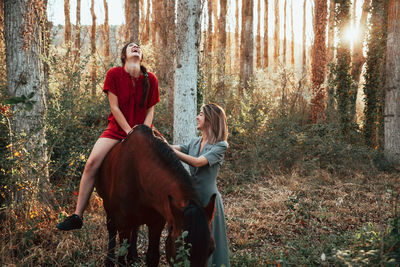 Full length of woman wearing hat in forest