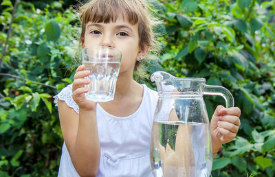 Portrait of woman drinking water