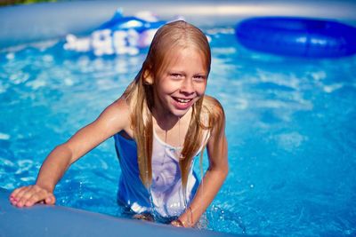 Portrait of wet girl in paddling pool