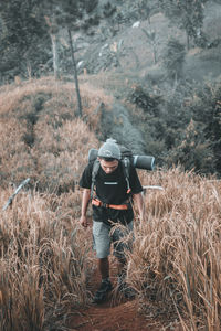 Rear view of man standing in forest