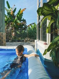 Rear view of boy in swimming pool